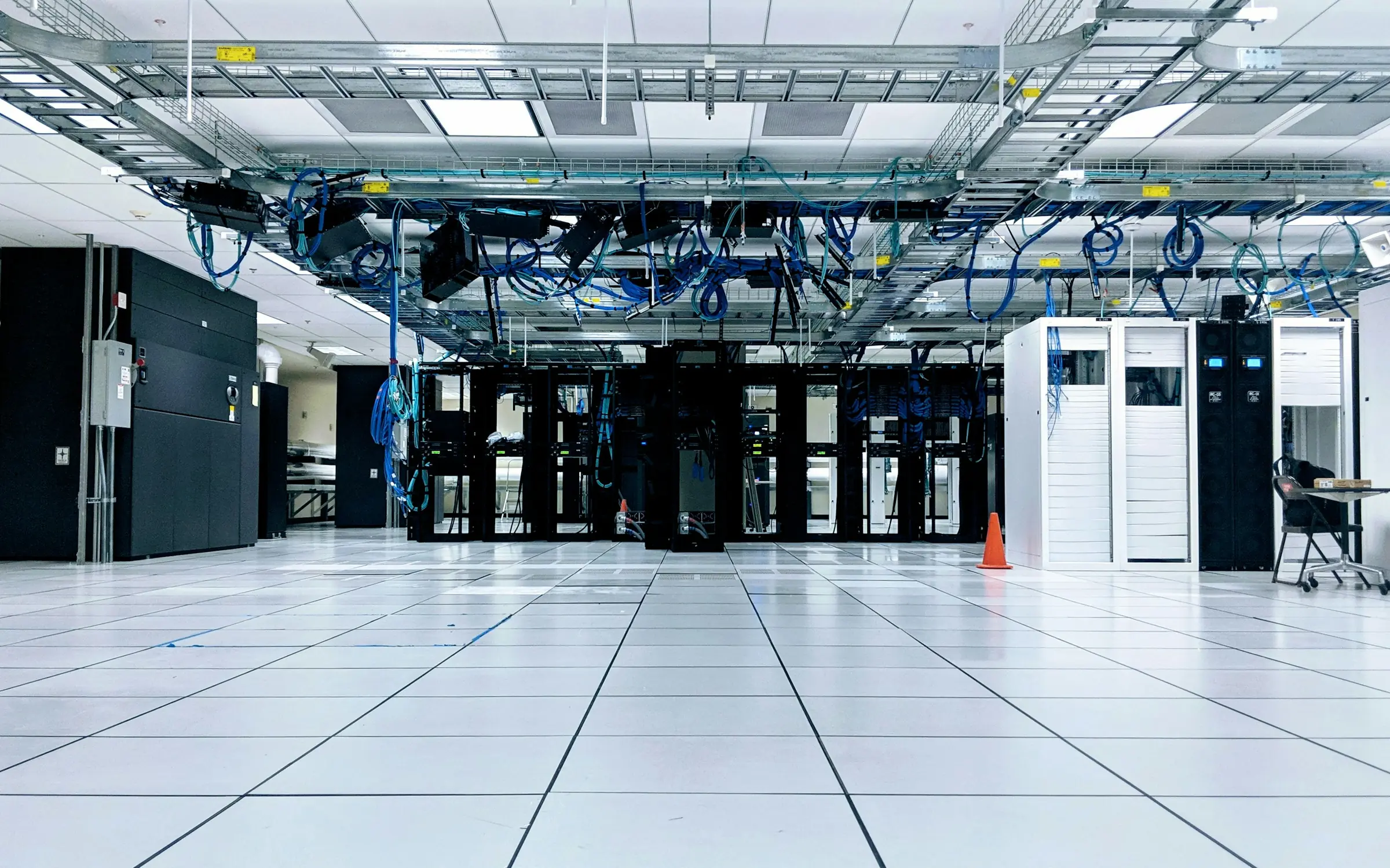 Rows of server cabinets in a bright data centre
