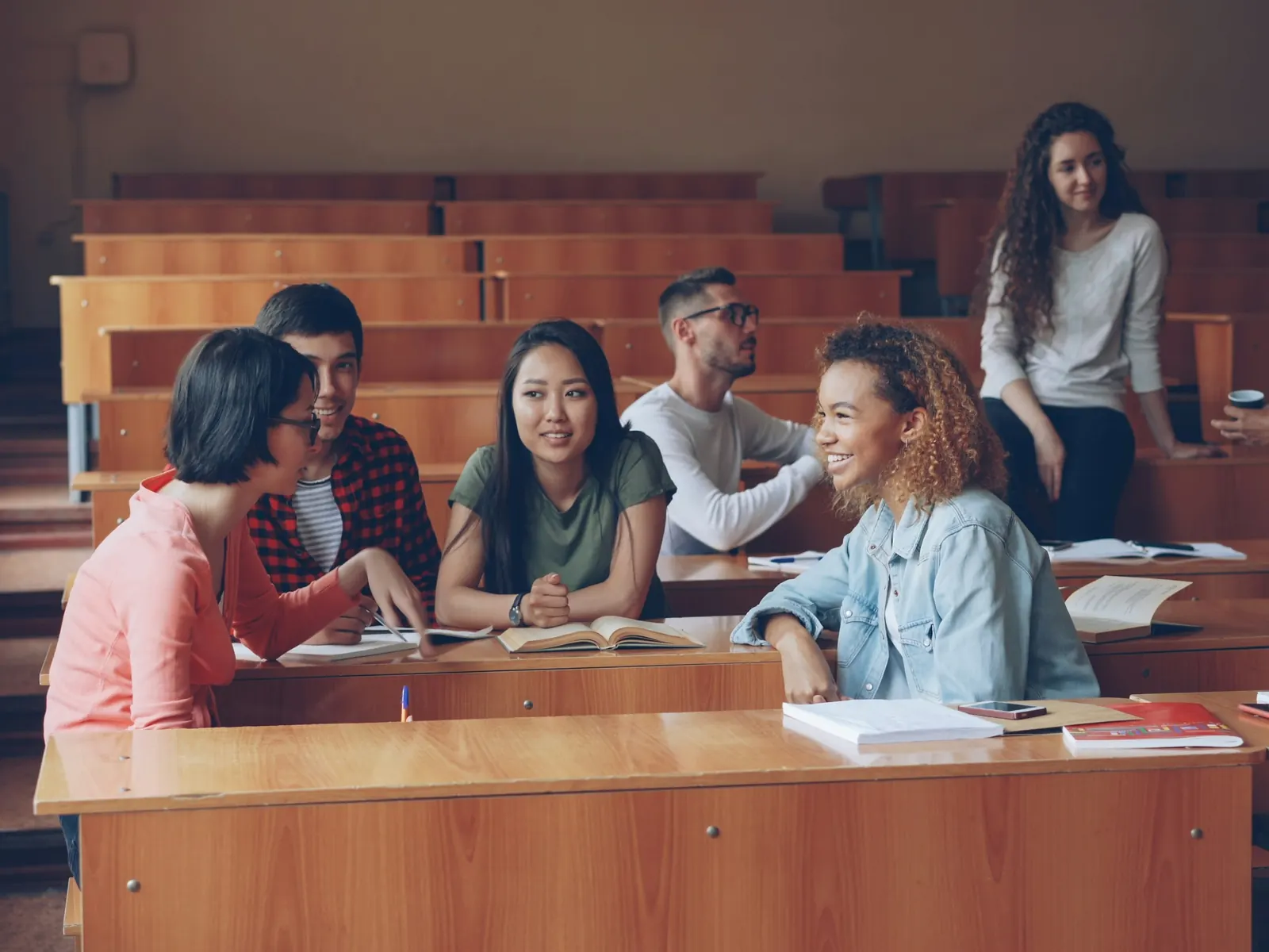 University students talking and studying in a lecture hall