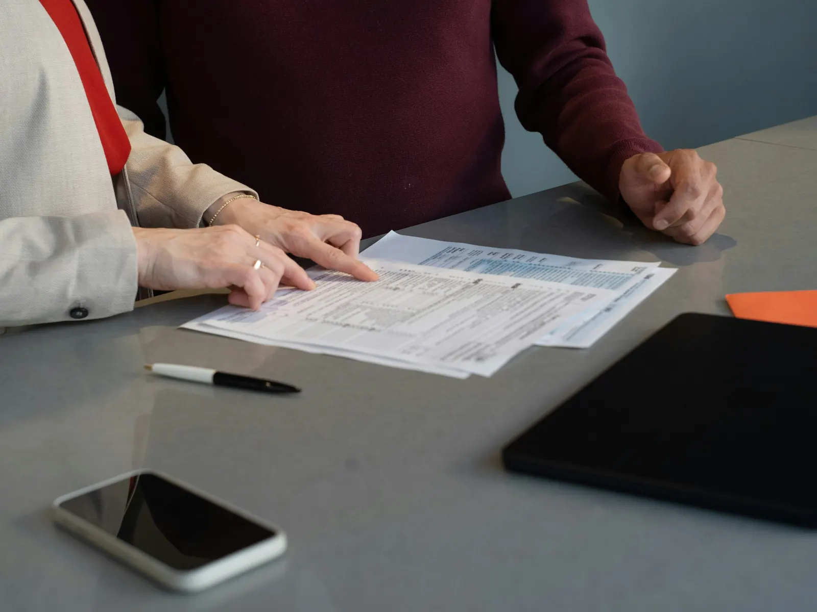 Two people reviewing an application form at a table