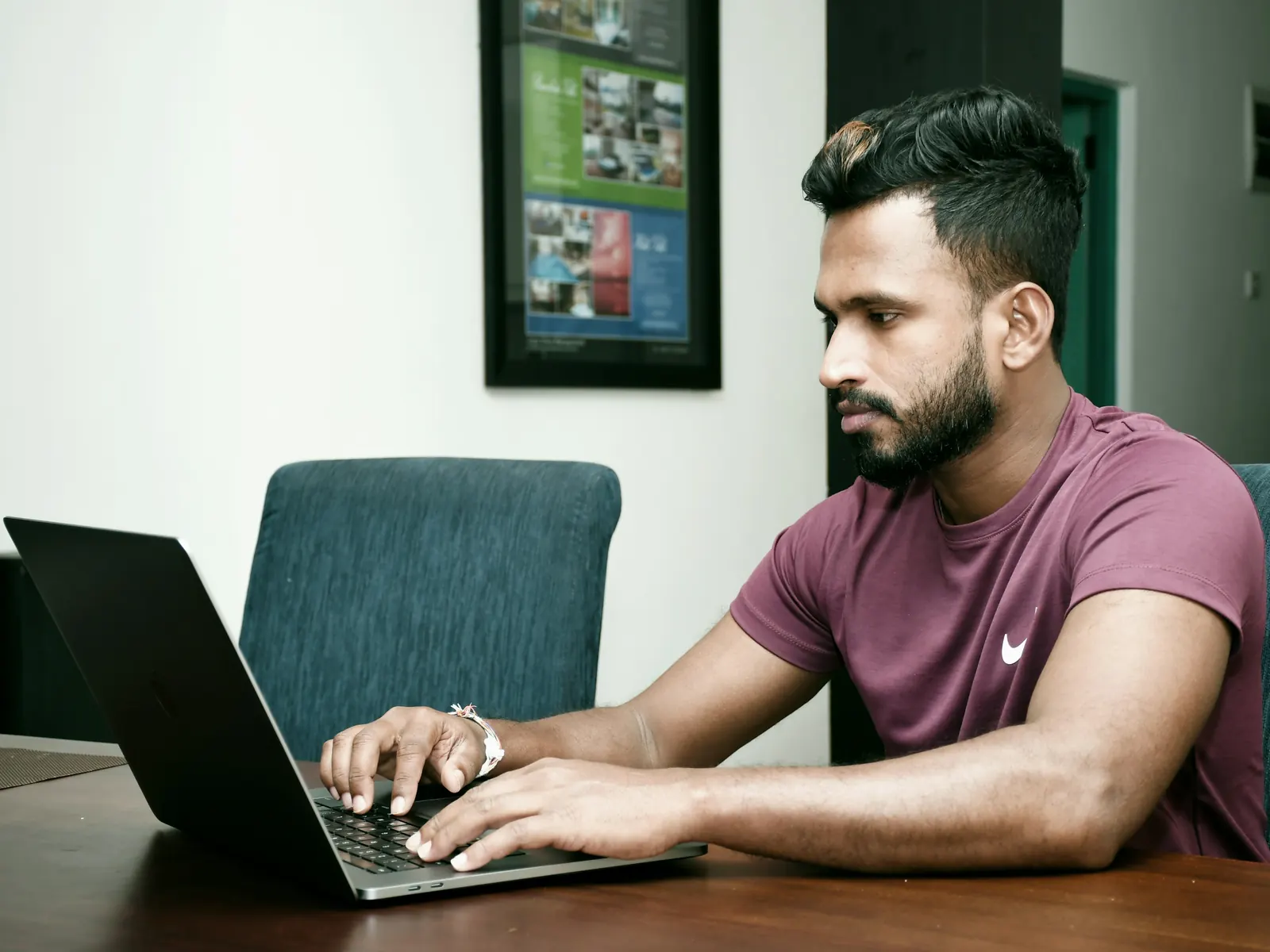Engineer focused on a laptop at an office desk